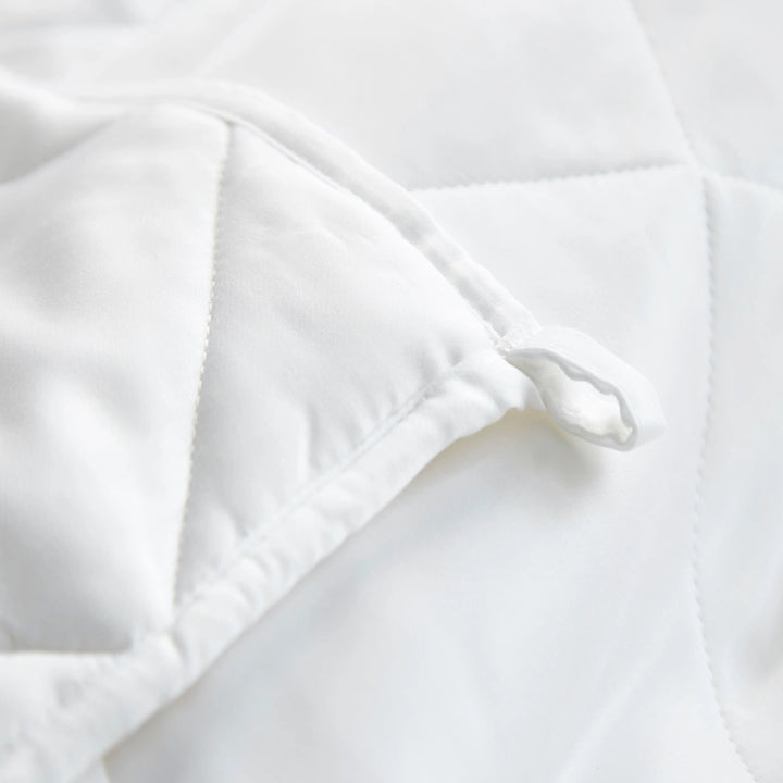 Detail of bamboo weighted blanket corner ties ensuring no-slip, stable fit inside duvet cover