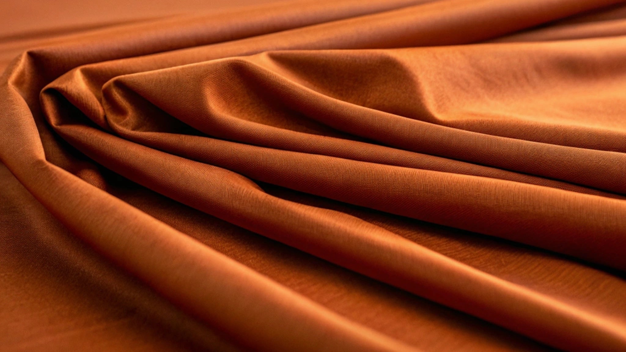 Close-up view of soft rust bamboo fabric showcasing the smooth weave and natural sheen of the material.