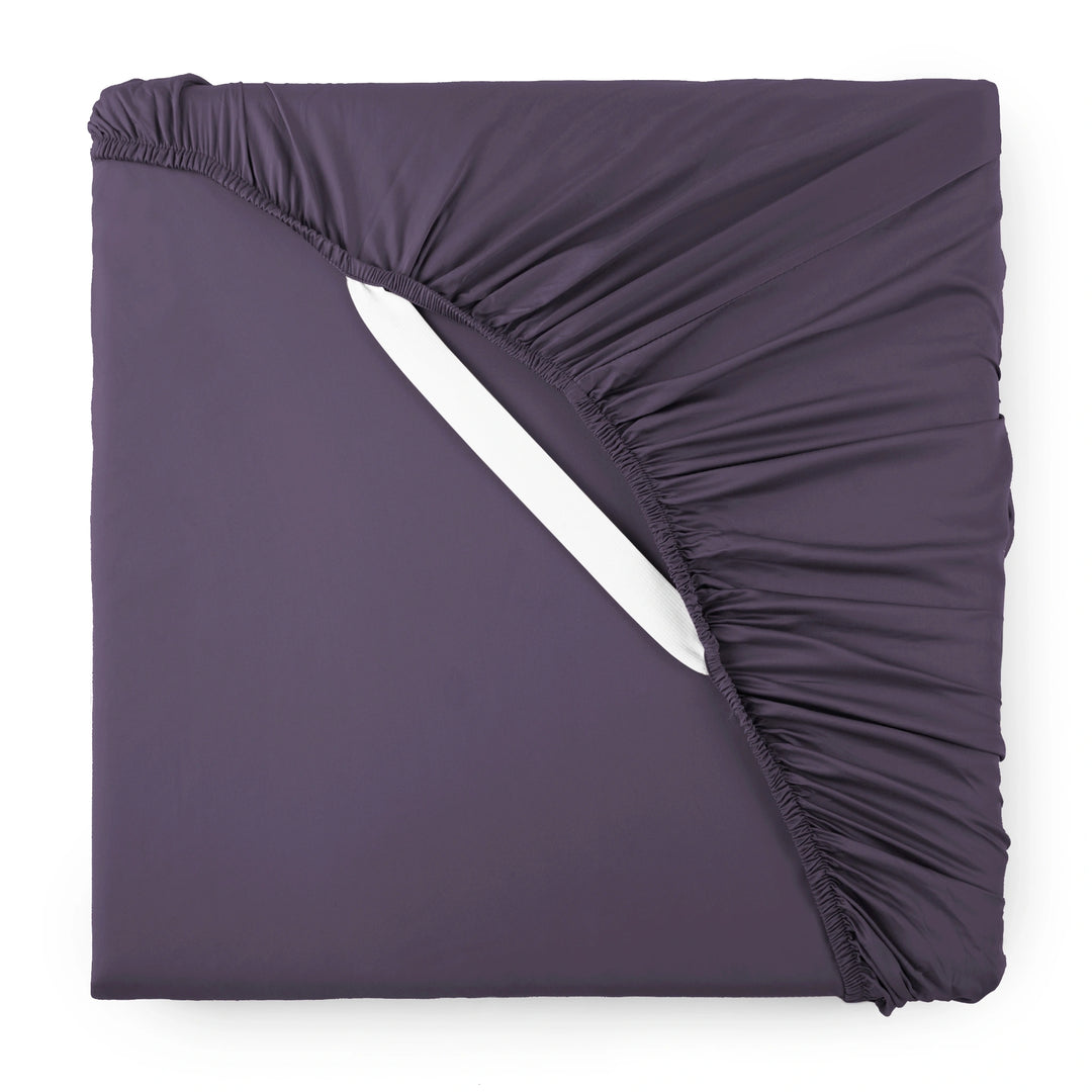 royal purple bamboo sateen fitted sheet corner with white elastic strap, showing snug fit and smooth fabric texture