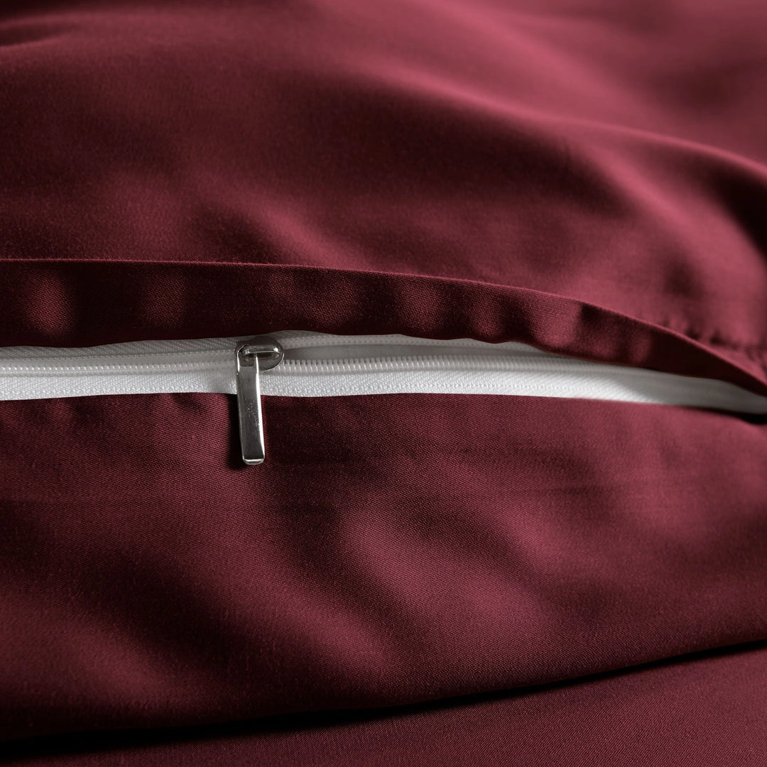 close-up of ruby red bamboo pillowcase with hidden ruby red zipper and smooth sateen finish