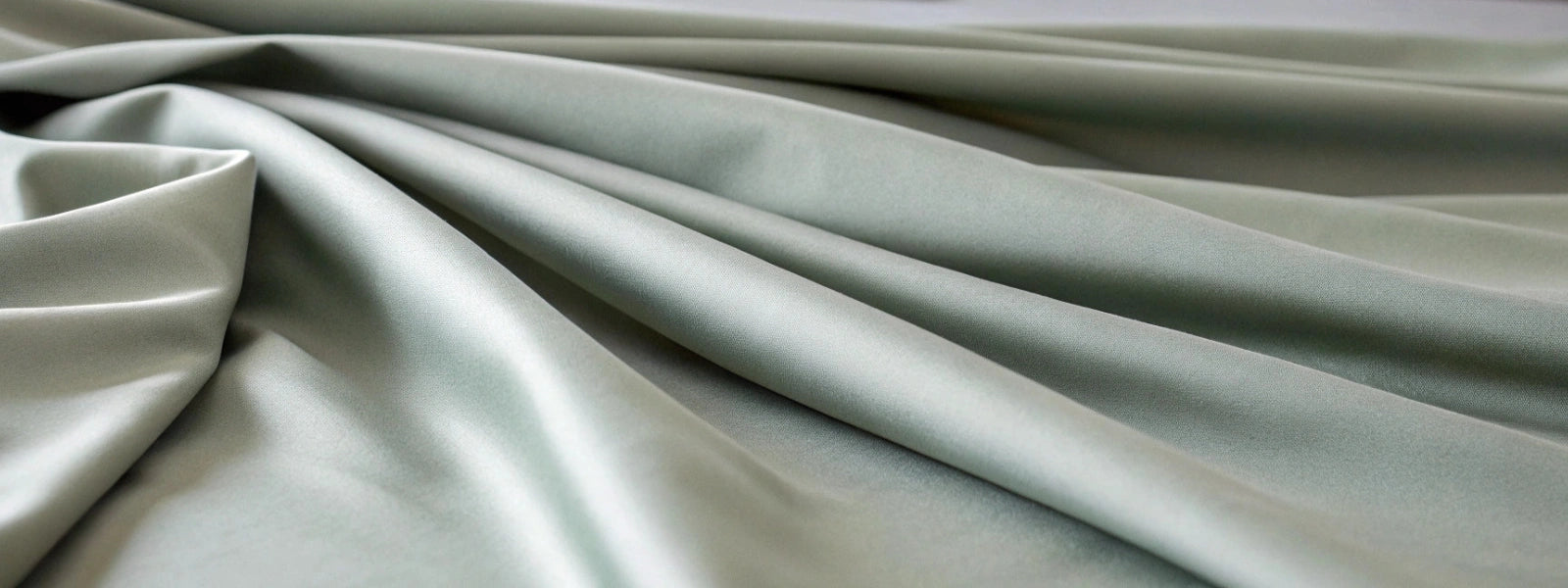 Close-up of silver bamboo sheet fabric showing its silky-smooth texture, subtle sheen, and high-quality weave.