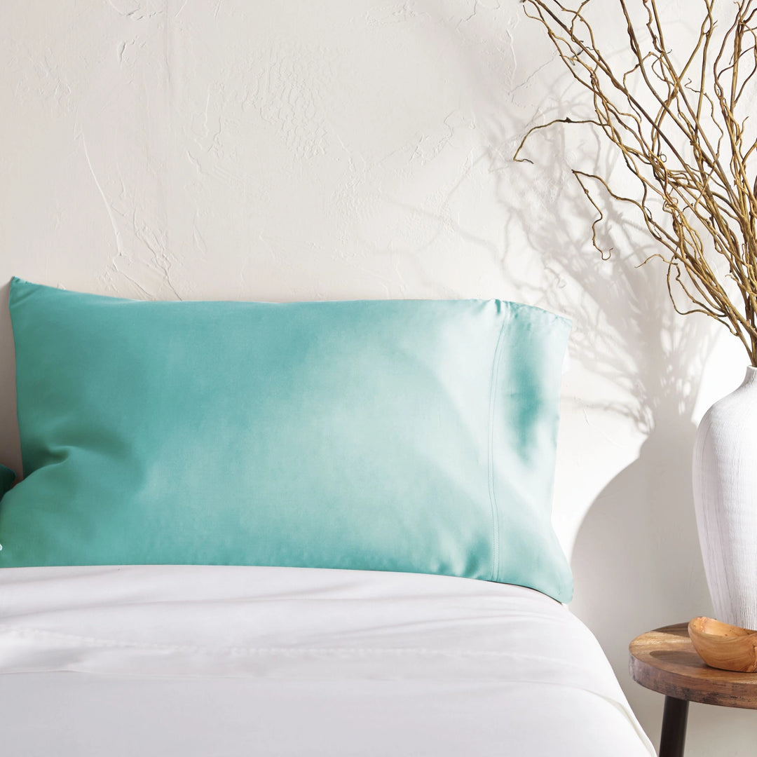 tiffany blue bamboo pillowcase on a tiffany blue bed from the Signature Collection, styled with vase decor and natural light