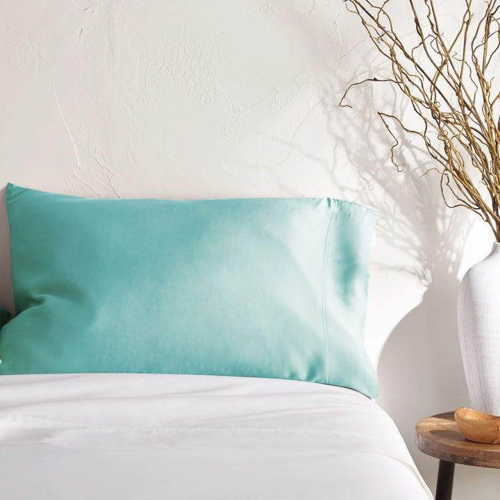 tiffany blue bamboo pillowcase on a tiffany blue bed from the Signature Collection, styled with vase decor and natural light
