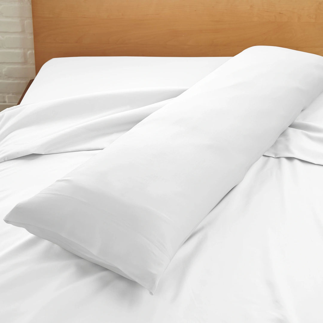 white bamboo body pillow with sateen weave from the Signature Collection, displayed on a white bed for contrast and texture focus