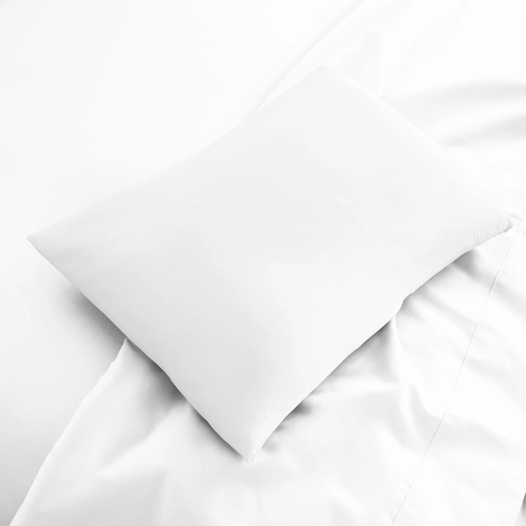 white bamboo lumbar pillowcase from the Signature Collection, displayed flat on white bedding with sateen finish and soft texture