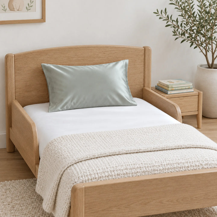 Silver cooling bamboo viscose toddler pillowcase on a light-oak toddler bed