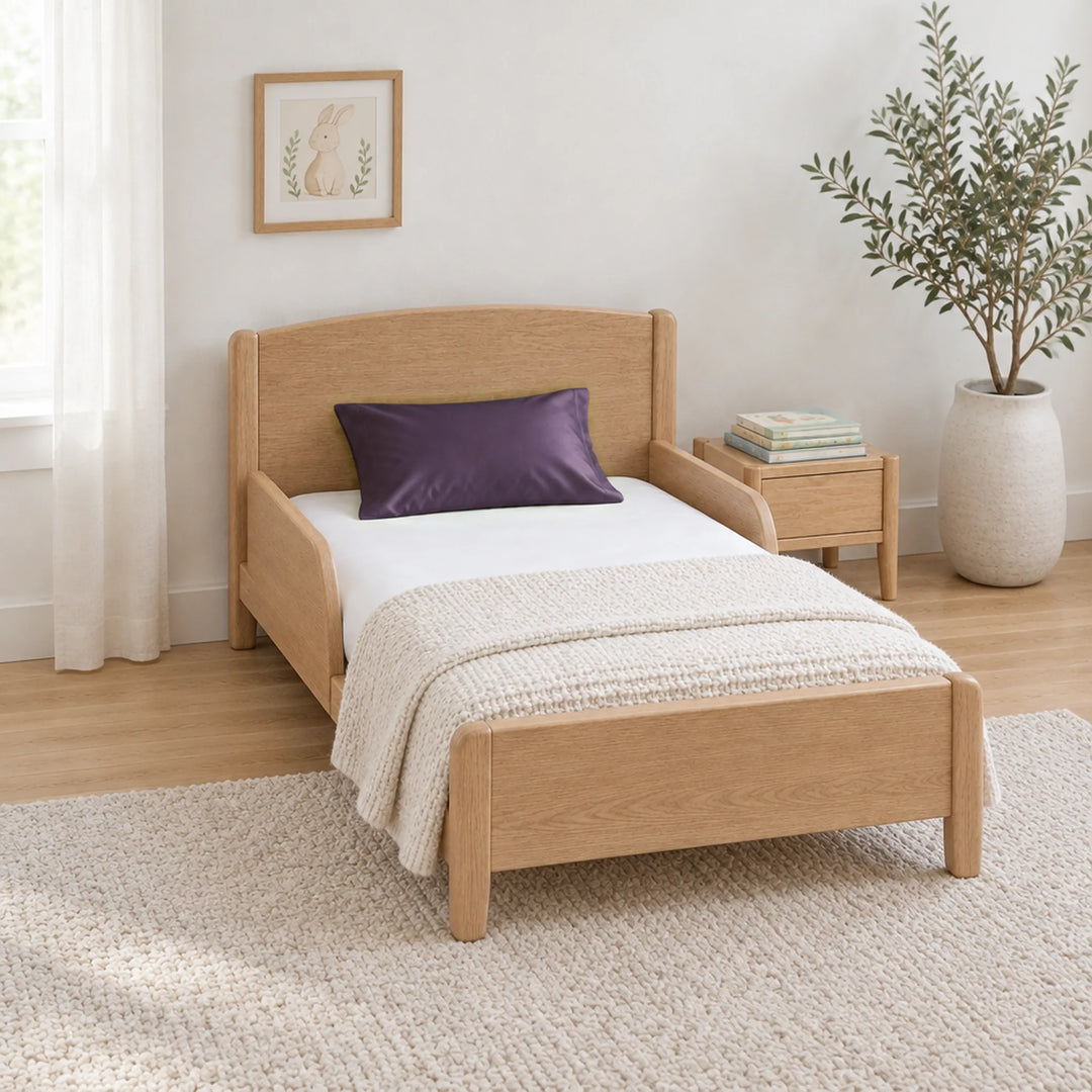 Royal purple cooling bamboo viscose toddler pillowcase on a toddler bed in a calm, light nursery