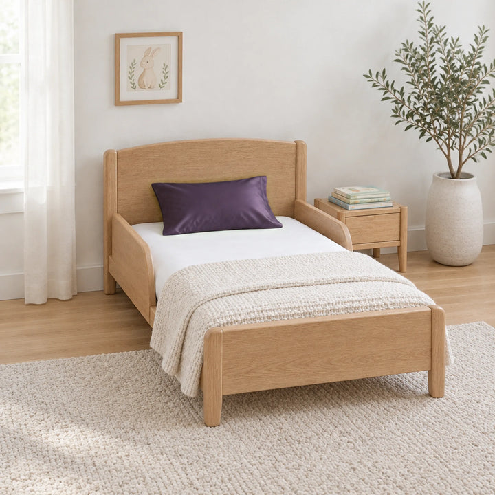 Royal purple cooling bamboo viscose toddler pillowcase on a toddler bed in a calm, light nursery