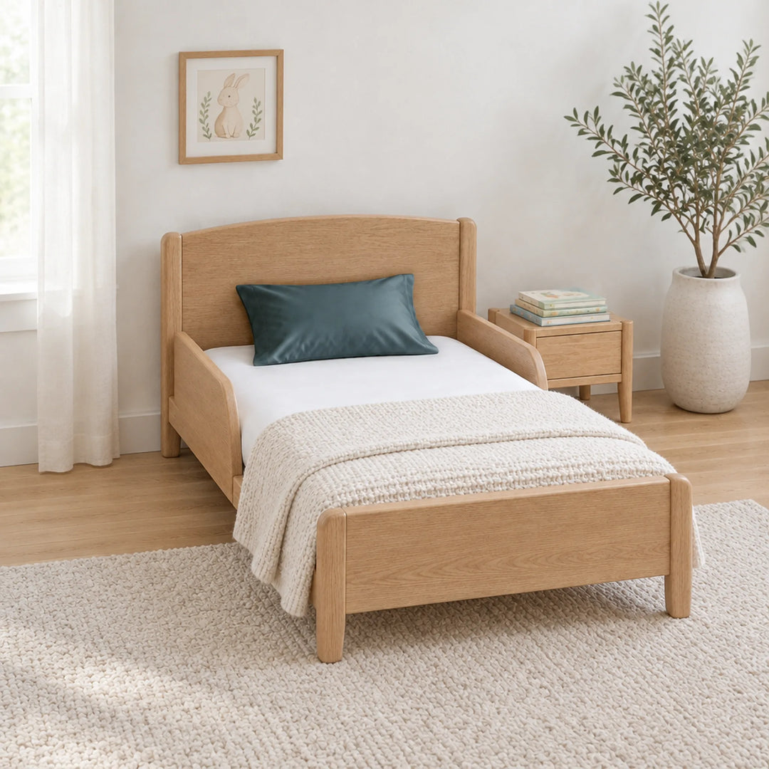 Slate cooling bamboo viscose toddler pillowcase on a toddler bed in a calm, light nursery