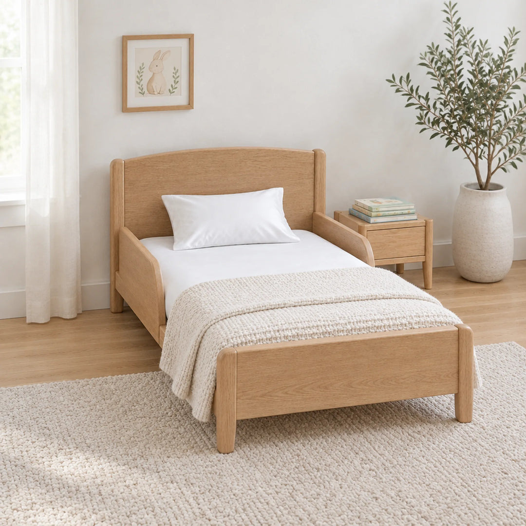 White cooling bamboo viscose toddler pillowcase on a toddler bed in a calm, light nursery