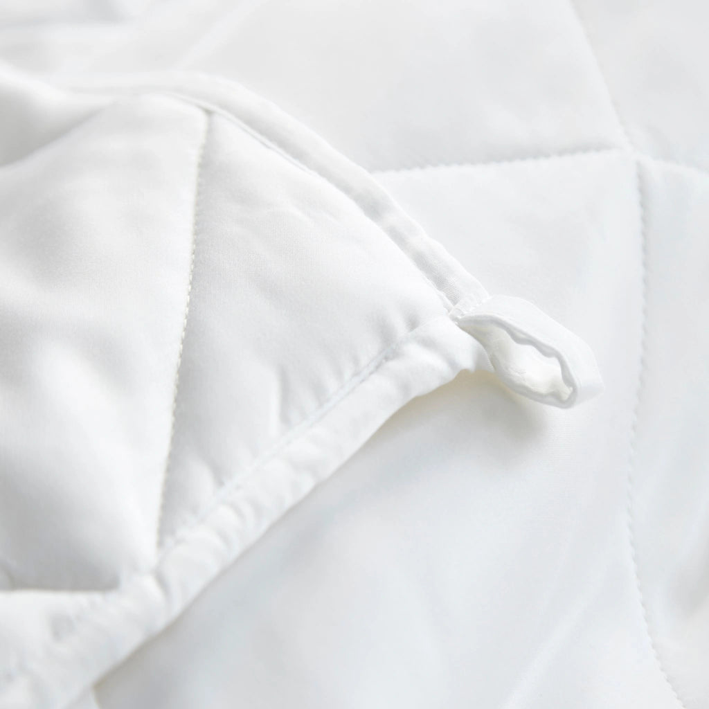 Close-up of bamboo comforter showing fabric tie at the corner, highlighting the functional detail for securing a duvet cover.