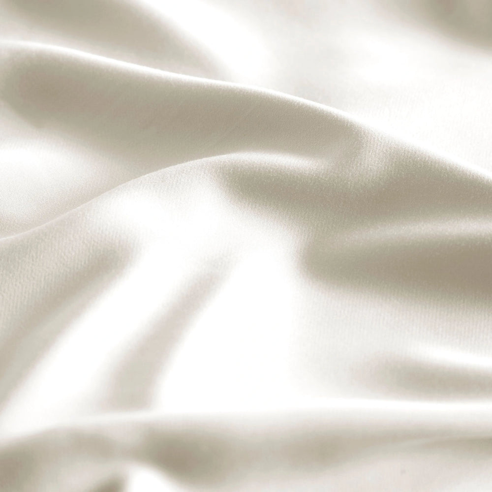 close-up of Cream bamboo bed sheets with sateen weave from the Premium Collection, highlighting silky texture and smooth drape