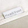 cream bamboo bed sheets with clearly labeled 'head' and 'foot' tags for easy bed-making