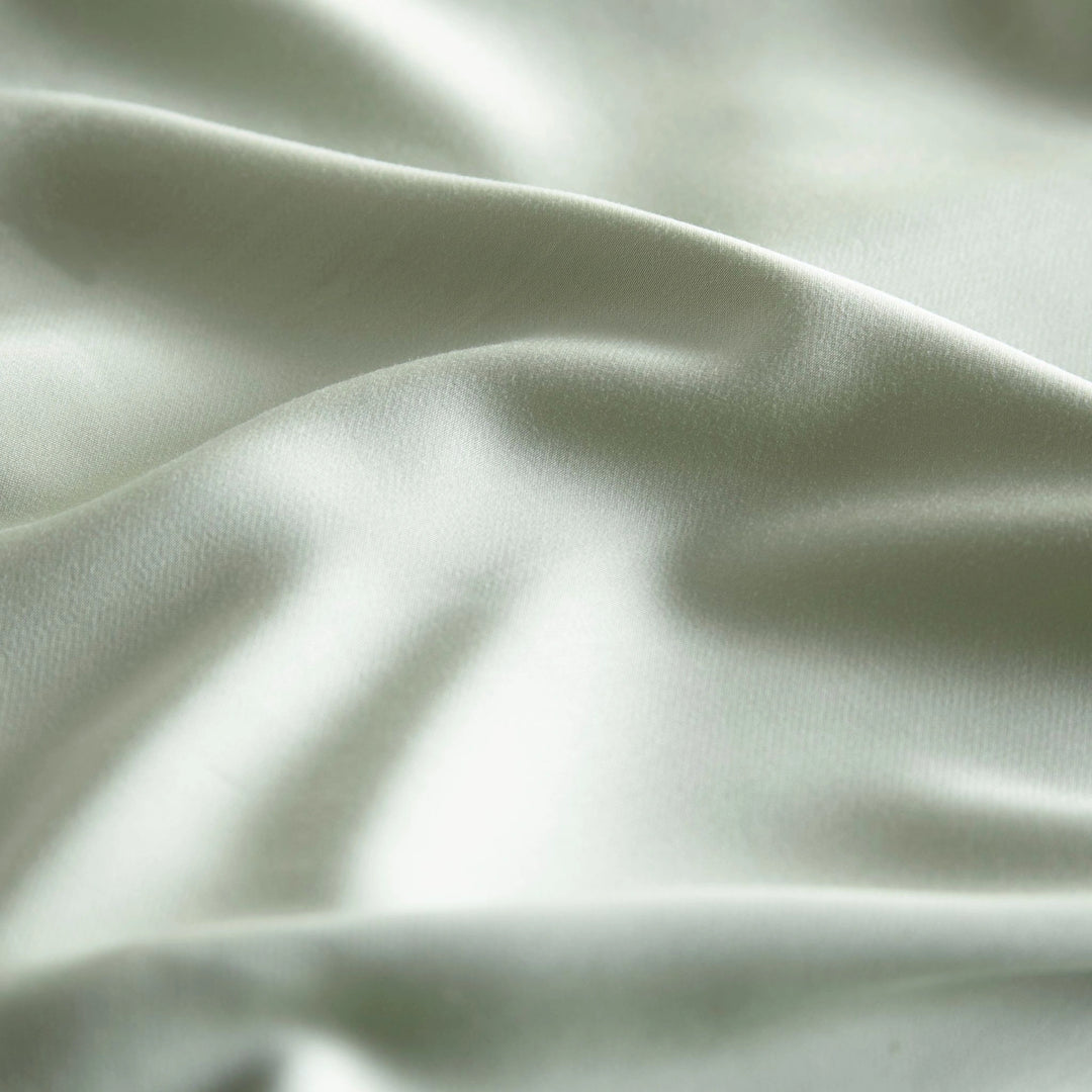 close-up of Sage bamboo bed sheets with sateen weave from the Premium Collection, highlighting silky texture and smooth drape