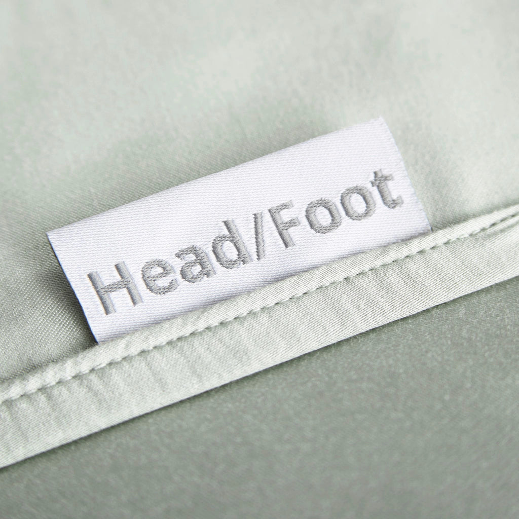 sage bamboo bed sheets with clearly labeled 'head' and 'foot' tags for easy bed-making