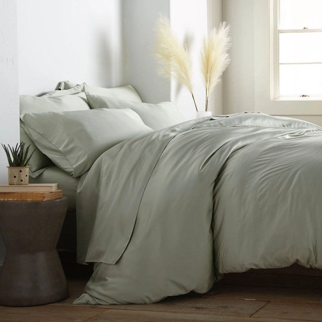 modern bedroom with Sage bamboo sateen sheet set on king bed, featuring matching pillowcases and duvet, styled with natural light and minimal decor