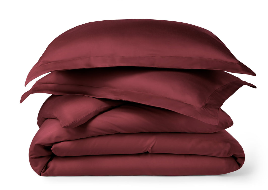ruby red bamboo duvet cover from the Signature Collection, neatly folded and stacked on a clean studio background