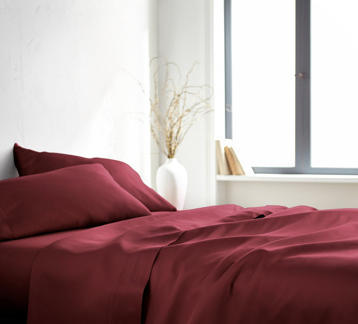 Ruby Red Signature Flat Sheet — silky sateen drape, side view