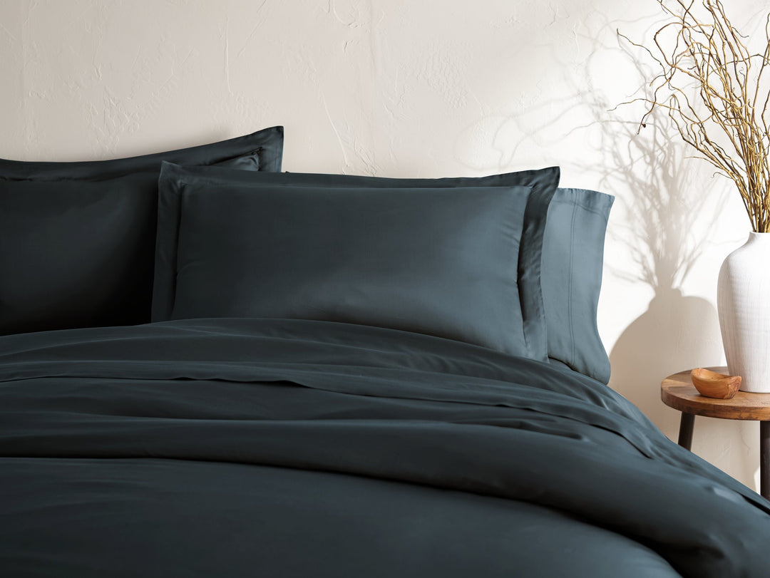slate bamboo duvet cover and matching shams from the Signature Collection, styled on a made king bed