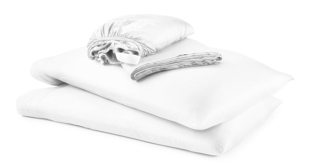 White bamboo Signature Collection sheet set neatly folded and stacked on a clean studio background