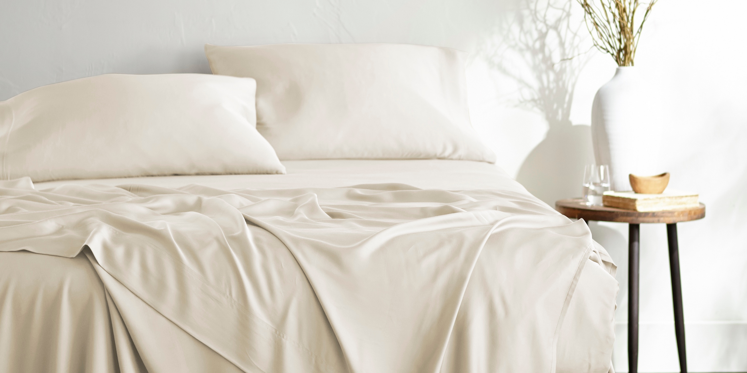 Luxurious bamboo bed sheets in neutral color on mattress – soft, cooling, and breathable