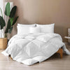 A bamboo comforter perfectly placed on a cozy white bed, highlighting its softness, warmth, and eco-friendly comfort.