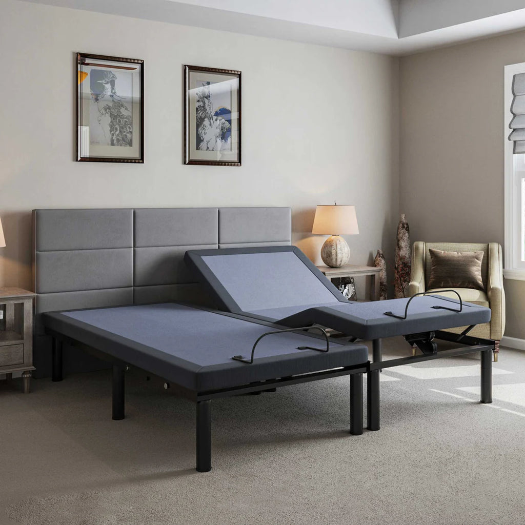 BT2000 split king adjustable bed base by Bamboo is Better shown with one side elevated in a cozy bedroom with gray headboard, lamps, and accent chair.