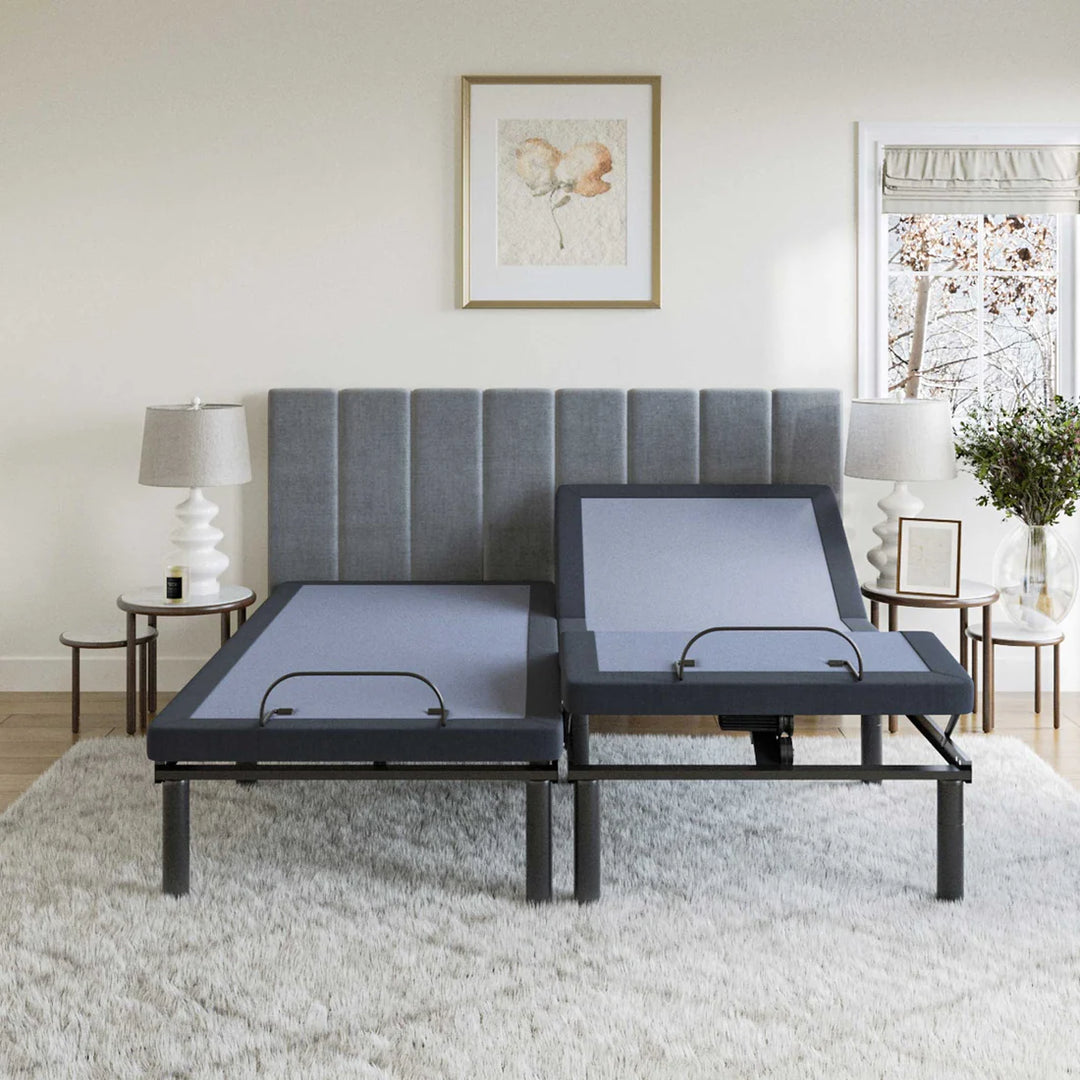BT2500 adjustable bed base by Bamboo is Better in split king configuration with one side raised in a modern light bedroom with gray headboard and side lamps.