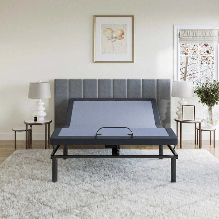 BT2500 adjustable bed base by Bamboo is Better with head and foot elevated in a bright bedroom with large windows and gray curtains.