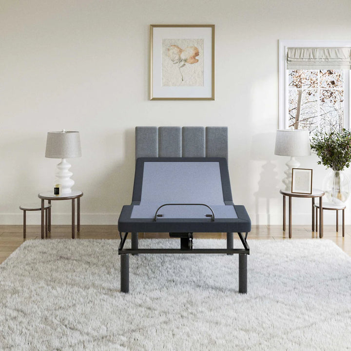 BT2500 Twin XL adjustable bed base by Bamboo is Better shown from the front with head elevated in a bright modern bedroom with gray headboard and decorative lamps.