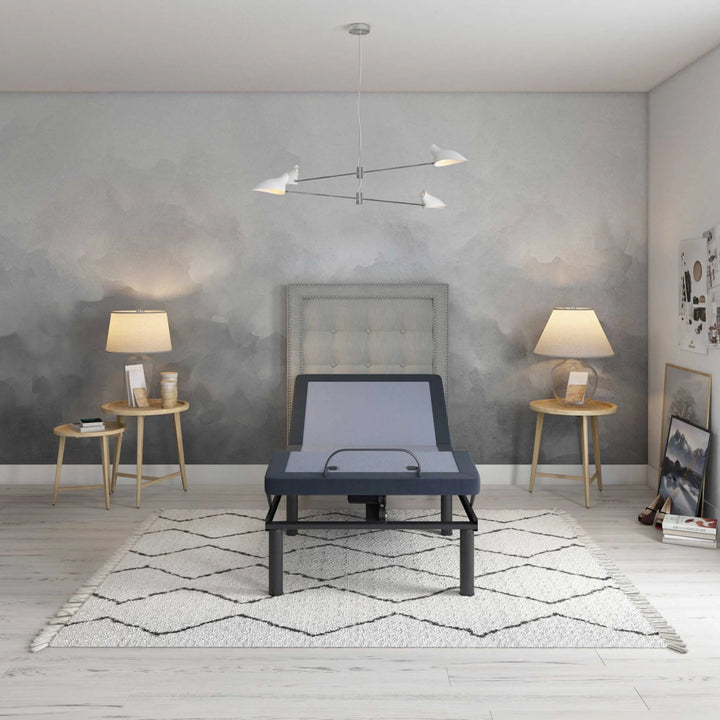 BT3000 adjustable bed base by Bamboo is Better shown from the front with head elevation in a modern gray bedroom with tufted headboard and warm lighting.