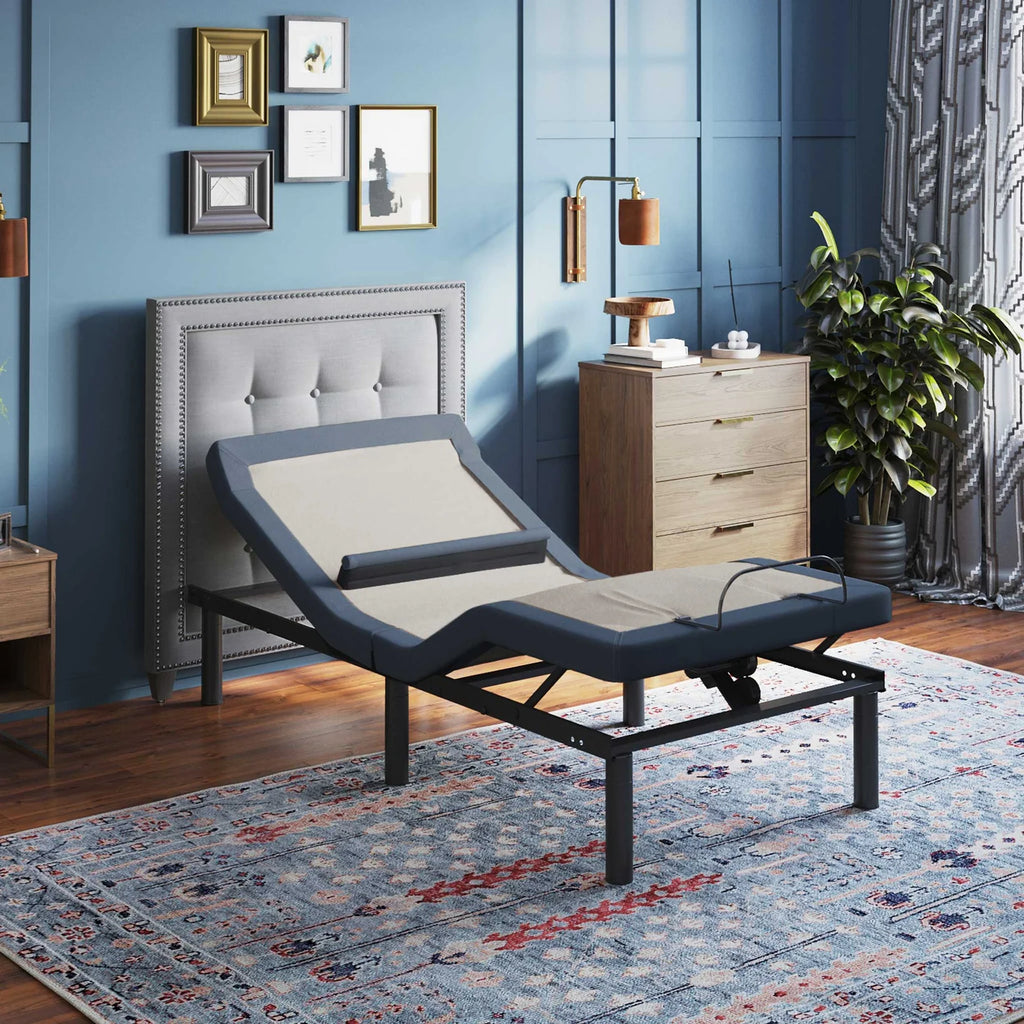 BT6500 Twin XL adjustable bed base by Bamboo is Better shown with head elevated in a modern bedroom with blue walls and wooden furniture.