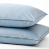 Two dusty blue bamboo pillowcases stacked, showing smooth twill weave and matte finish. Cooling and antibacterial, ideal for hot sleepers and sensitive skin.