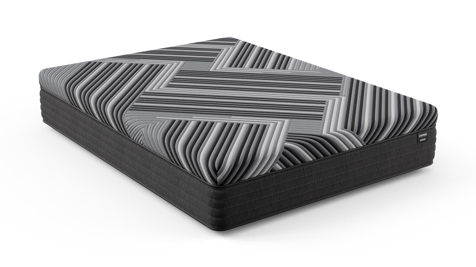 Three-quarter angled view of the Copper Calm Hybrid mattress by Bamboo is Better, showing its gray and black geometric pattern and hybrid foam-and-spring construction on a white background.