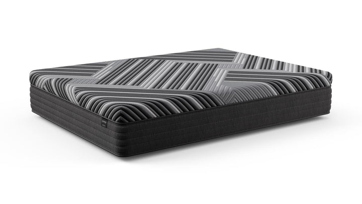Angled view of the Copper Calm Hybrid mattress by Bamboo is Better, showing its gray and black geometric design and plush hybrid construction on a white background.