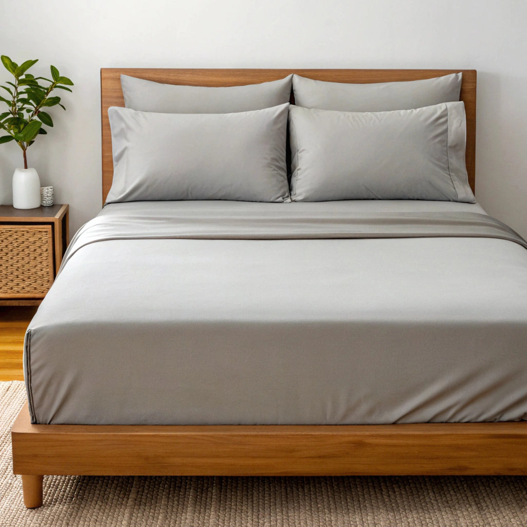 Angled view from the foot of the bed showing the feather gray  bamboo sheets with a soft finish and elegant bed styling.