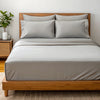 Angled view from the foot of the bed showing the feather gray  bamboo sheets with a soft finish and elegant bed styling.