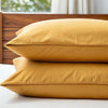 Set of two mustard bamboo pillowcases stacked, showcasing smooth texture and cooling performance for healthier sleep.