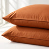 Two burnt orange bamboo pillowcases stacked with a warm matte finish, made for breathable, skin-supportive sleep.