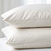 Set of two powder white bamboo pillowcases stacked, designed for hypoallergenic comfort and naturally cooling sleep.