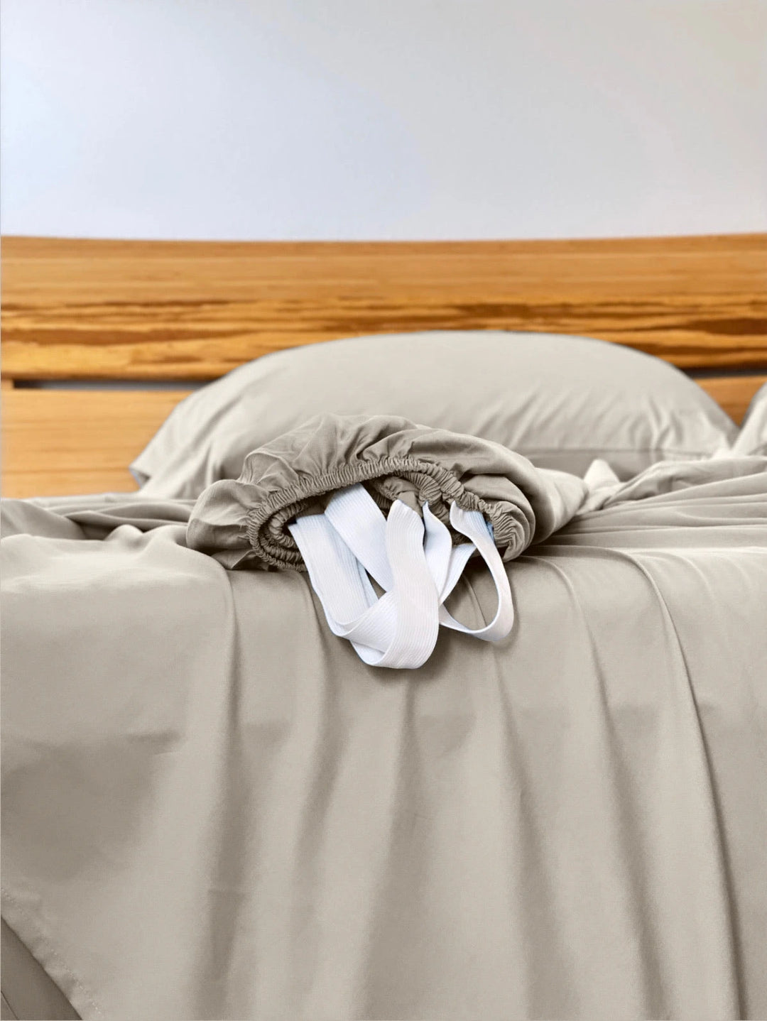 Summer Sand copper-infused bamboo fitted sheet — corner detail showing the elastic hem and reinforced corner straps for a secure fit.