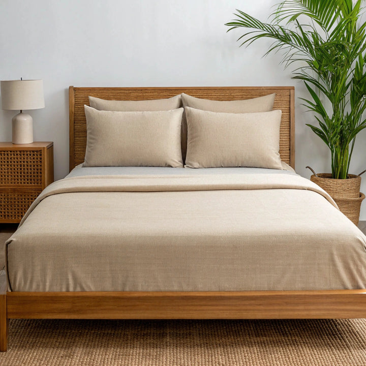 Angled view from the foot of the bed showing the summer sand bamboo sheets with a soft finish and elegant bed styling.