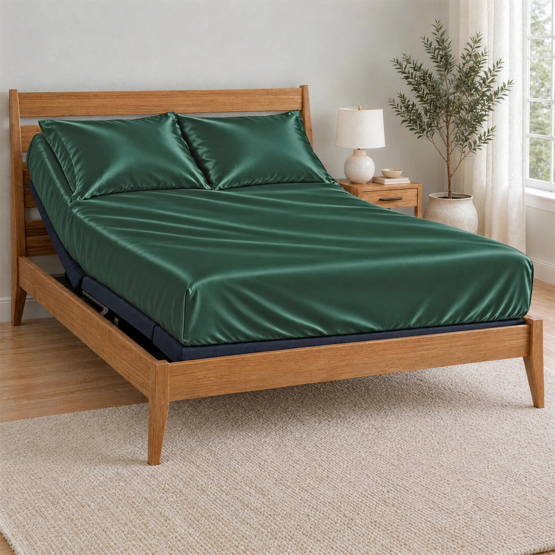 Emerald Green bamboo viscose Signature fitted sheet on a made bed with a bamboo frame and nightstand in a bright bedroom