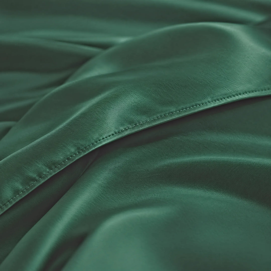 Emerald Green bamboo viscose sateen body pillowcase macro close-up of silky sateen folds and stitched envelope closure