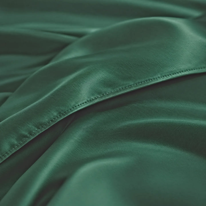 Emerald Green bamboo viscose sateen body pillowcase macro close-up of silky sateen folds and stitched envelope closure