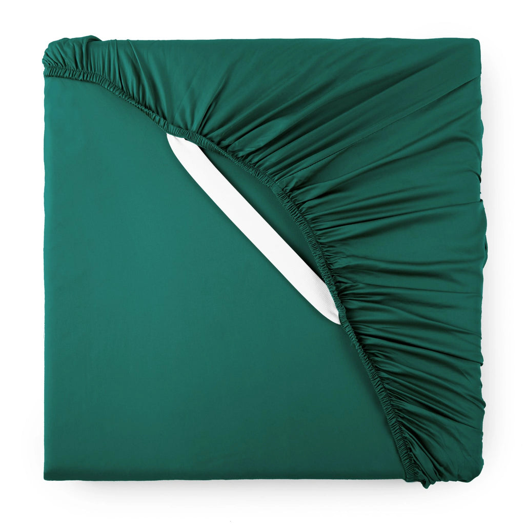 emerald green bamboo sateen fitted sheet corner with emerald green elastic strap, showing snug fit and smooth fabric texture