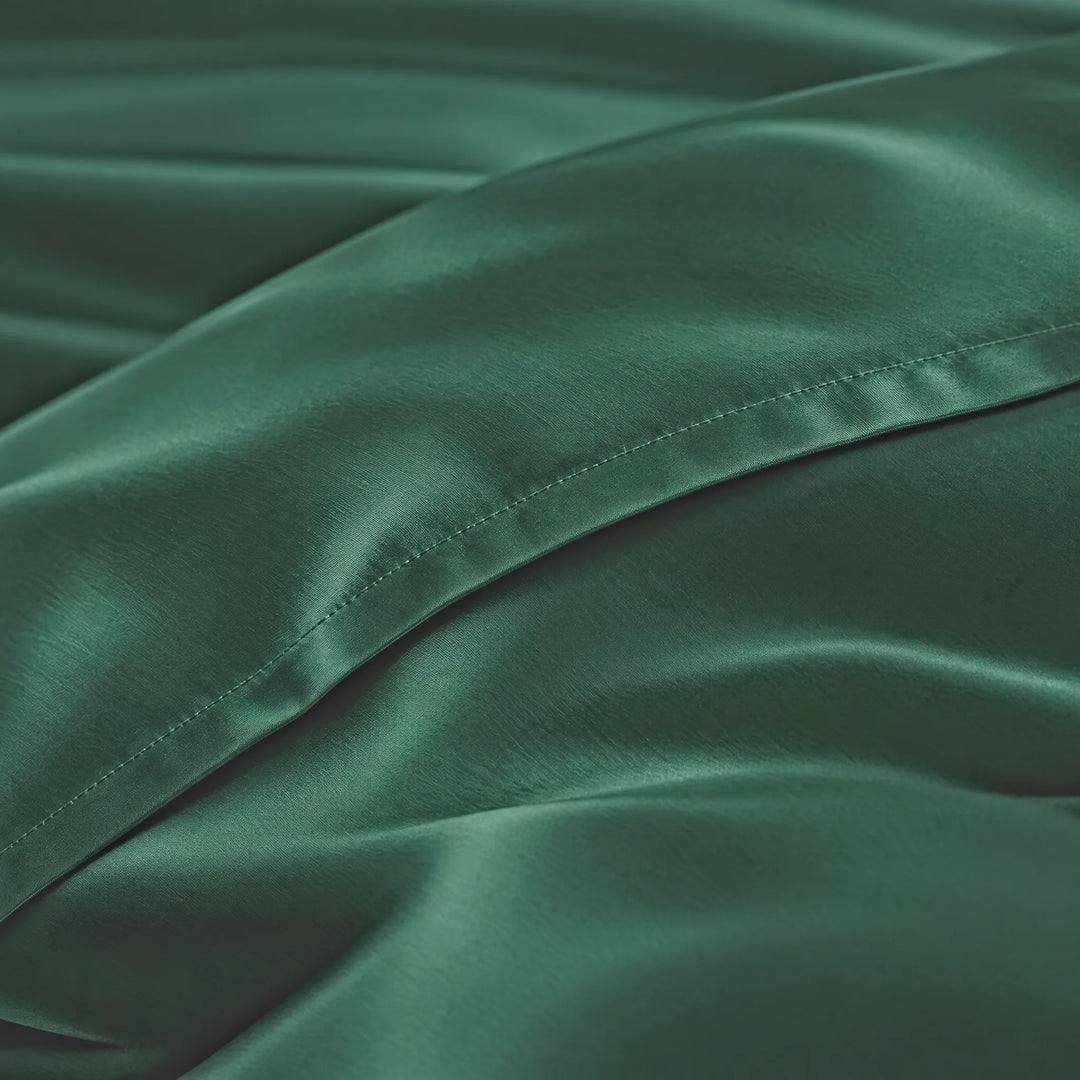 Emerald Green bamboo viscose sateen lumbar pillowcase macro close-up of silky sateen folds and stitched hem