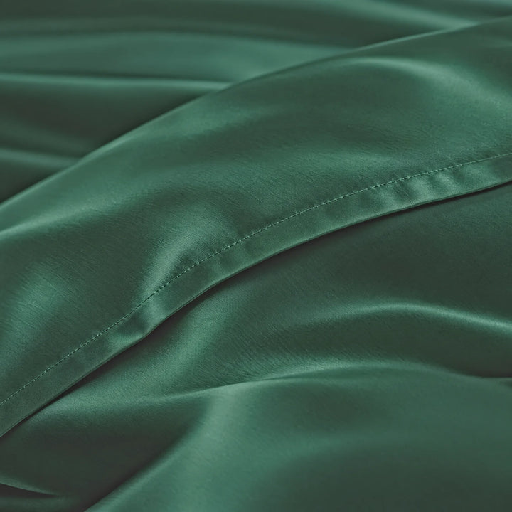 Emerald Green bamboo viscose sateen lumbar pillowcase macro close-up of silky sateen folds and stitched hem