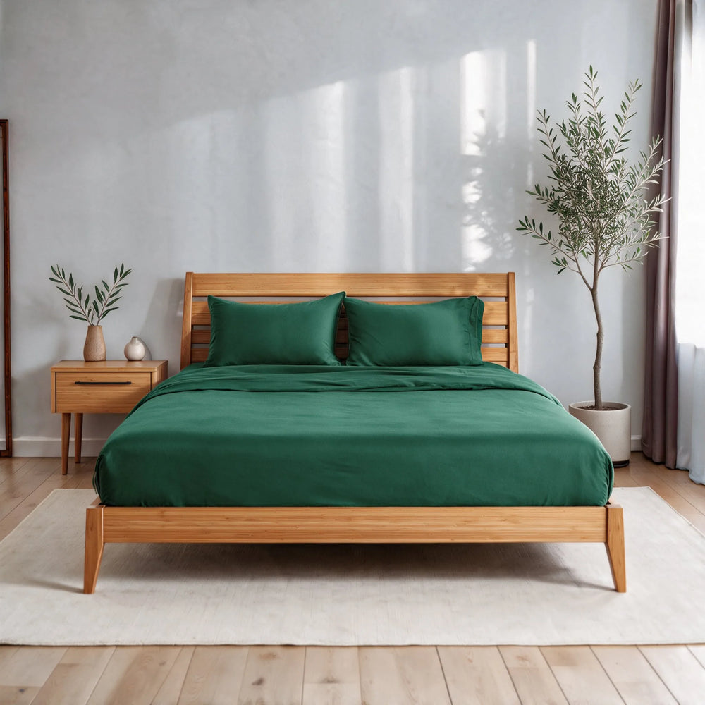emerald green bamboo viscose sateen sheet set on a caramelized bamboo bed frame in a bright bedroom with a cream rug