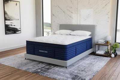 Angled view of the Generations 2.0 Luxe Hand-Tufted Latex Hybrid Mattress in a modern bedroom with marble accent wall and light wood floors